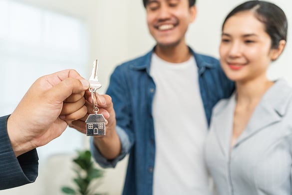 Couple receiving key of their new house Couple receiving key of their new house