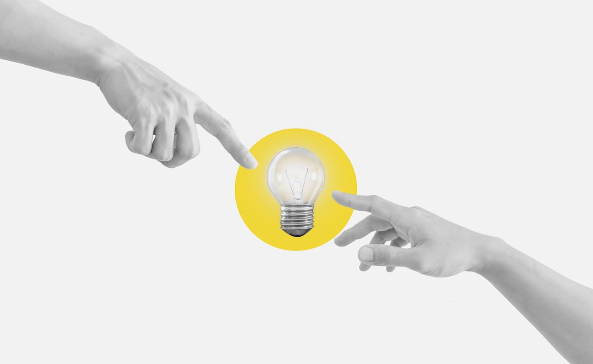 Hands reaching glowing light bulb