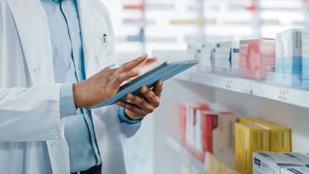 pharmacist checking stock with digital system