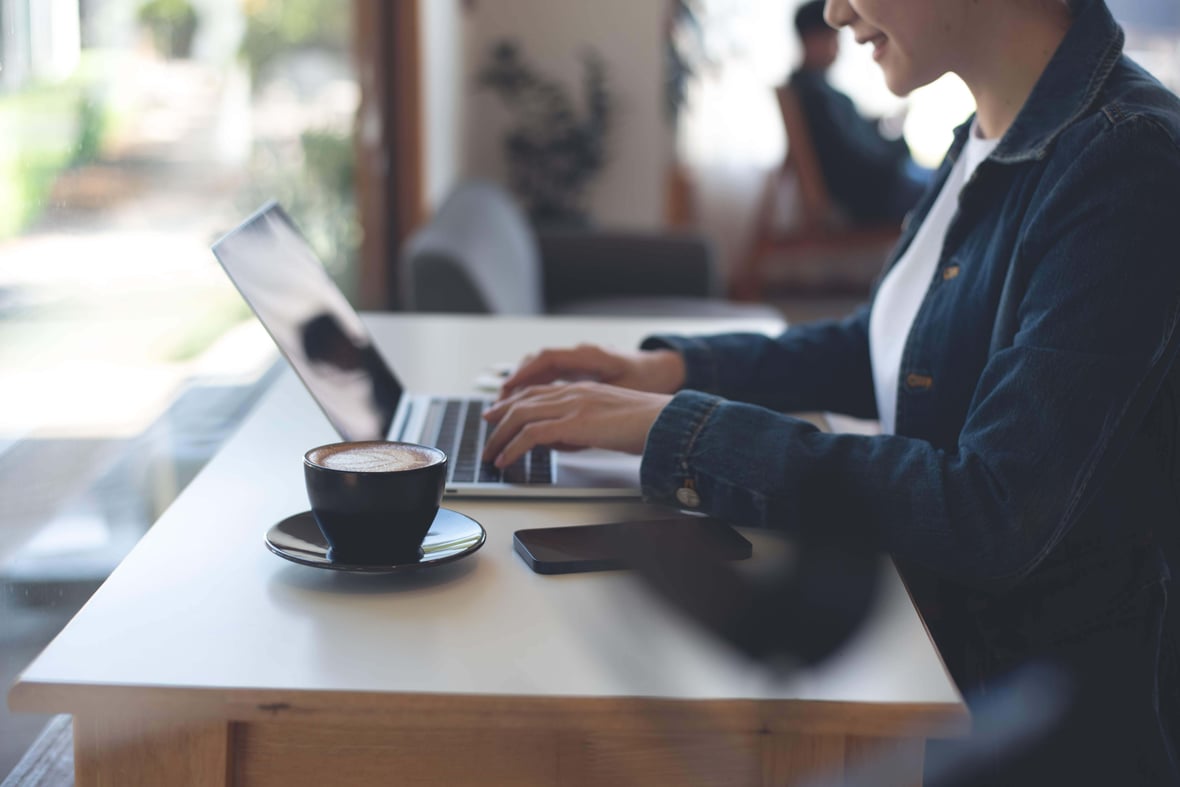 person typing on laptop with coffee - liantis case person typing on laptop with coffee - liantis case